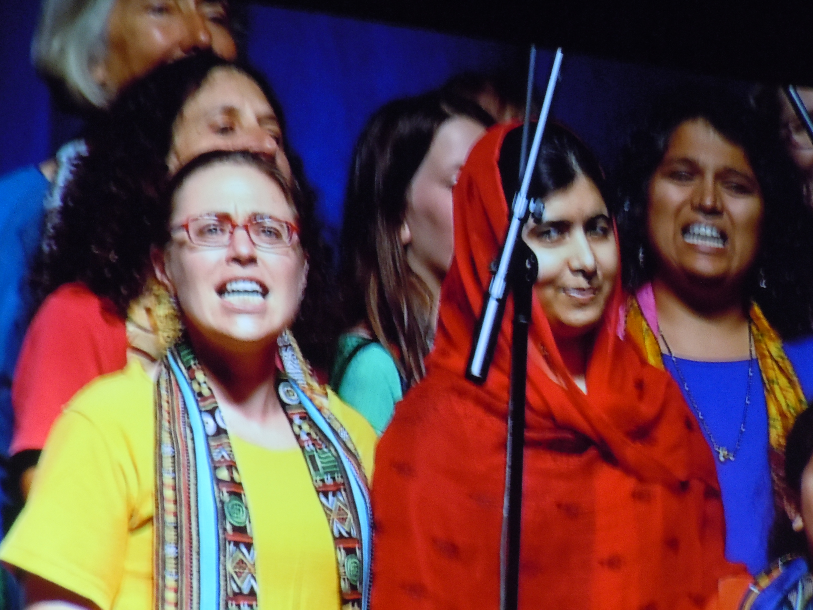 Malala amidst members of Amandla Chorus, serenading her. Photo by Shel Horowitz